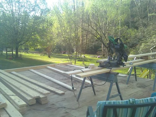 Miter saw and framing lumber on a deck under construction in Seaside